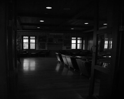 Dark spacious room with minimal lighting and mats